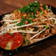 Plastic container full of pad thai noodles